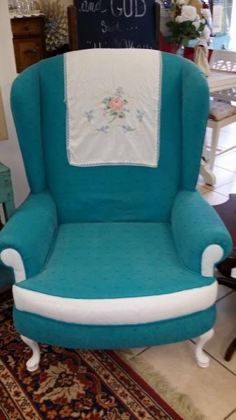We gave this chair an updated look with a bright blue upholstery and white accents.