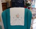 We gave this chair an updated look with a bright blue upholstery and white accents.